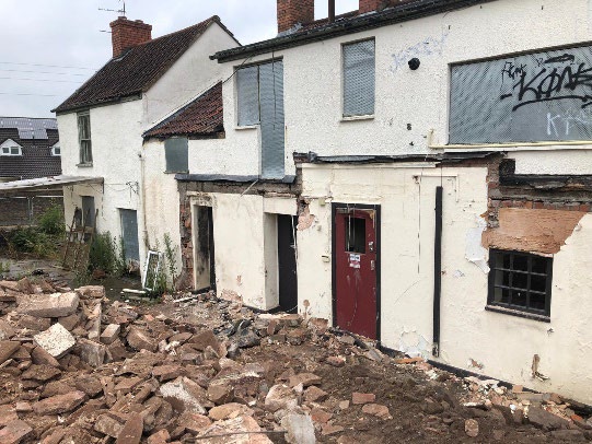 Rear of the retained Live & Let Live building with demolition arisings