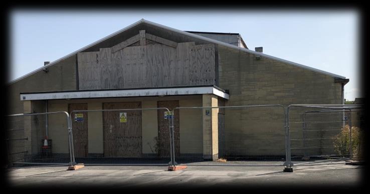 Boarded building at the Sladebrook Road project before clearance
