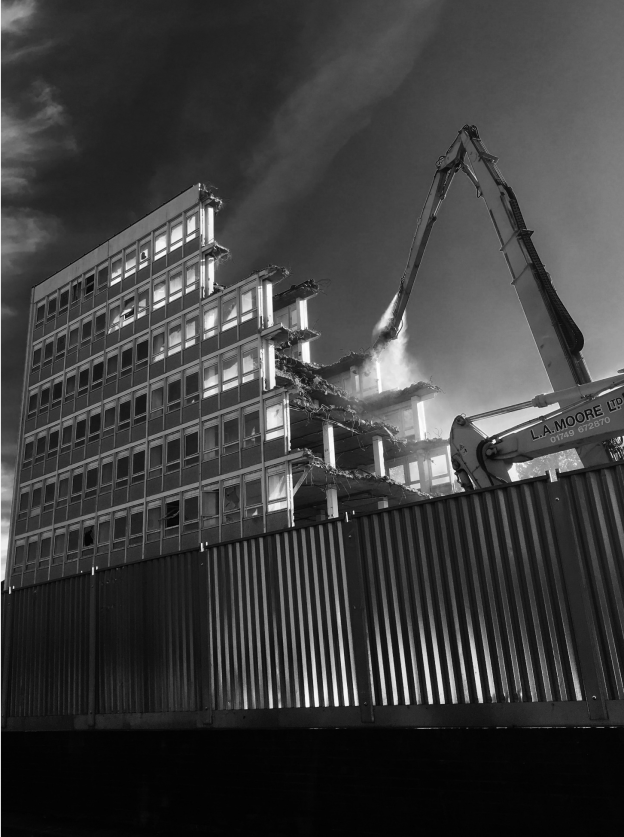 L A Moore high-reach excavator carrying out demolition in Taunton