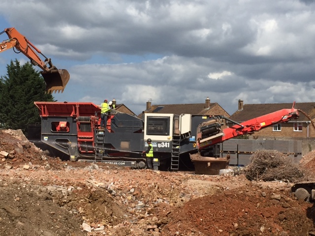 L A Moore Ltd mobile crusher working on site, crushing and recycling hardcore