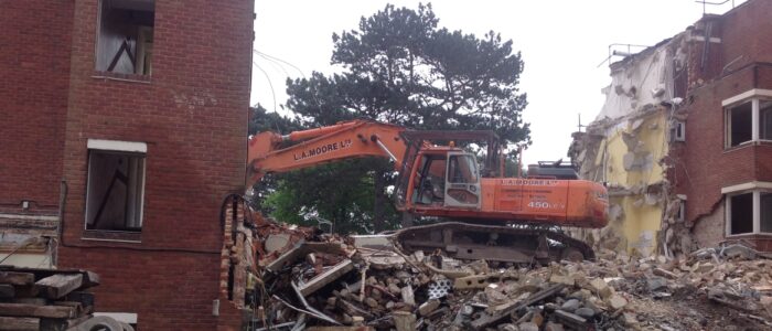 A 45 tonne excavator being used to safely demolish one of the buildings.