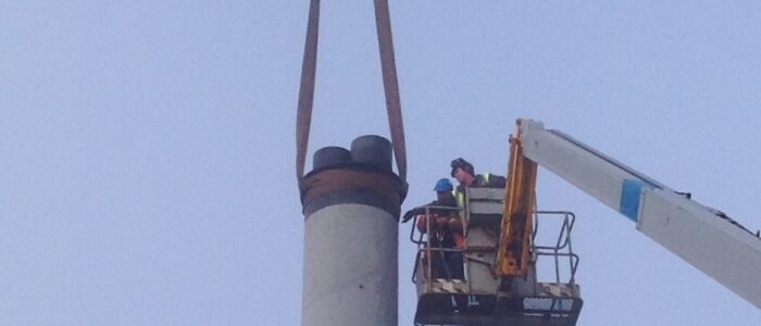 Strapping around the top of the chimney allows it to be lifted by crane