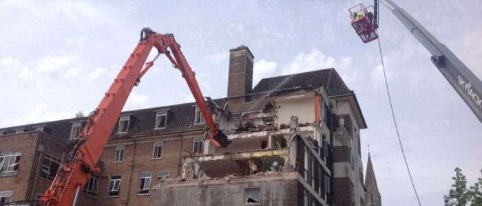 Hi-Reach excavator demolishing the top floors of Cardiff Royal Infirmary